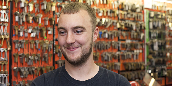 A man smiling in a key cutting shop