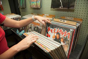 Someone looking through a stack of records in a shop