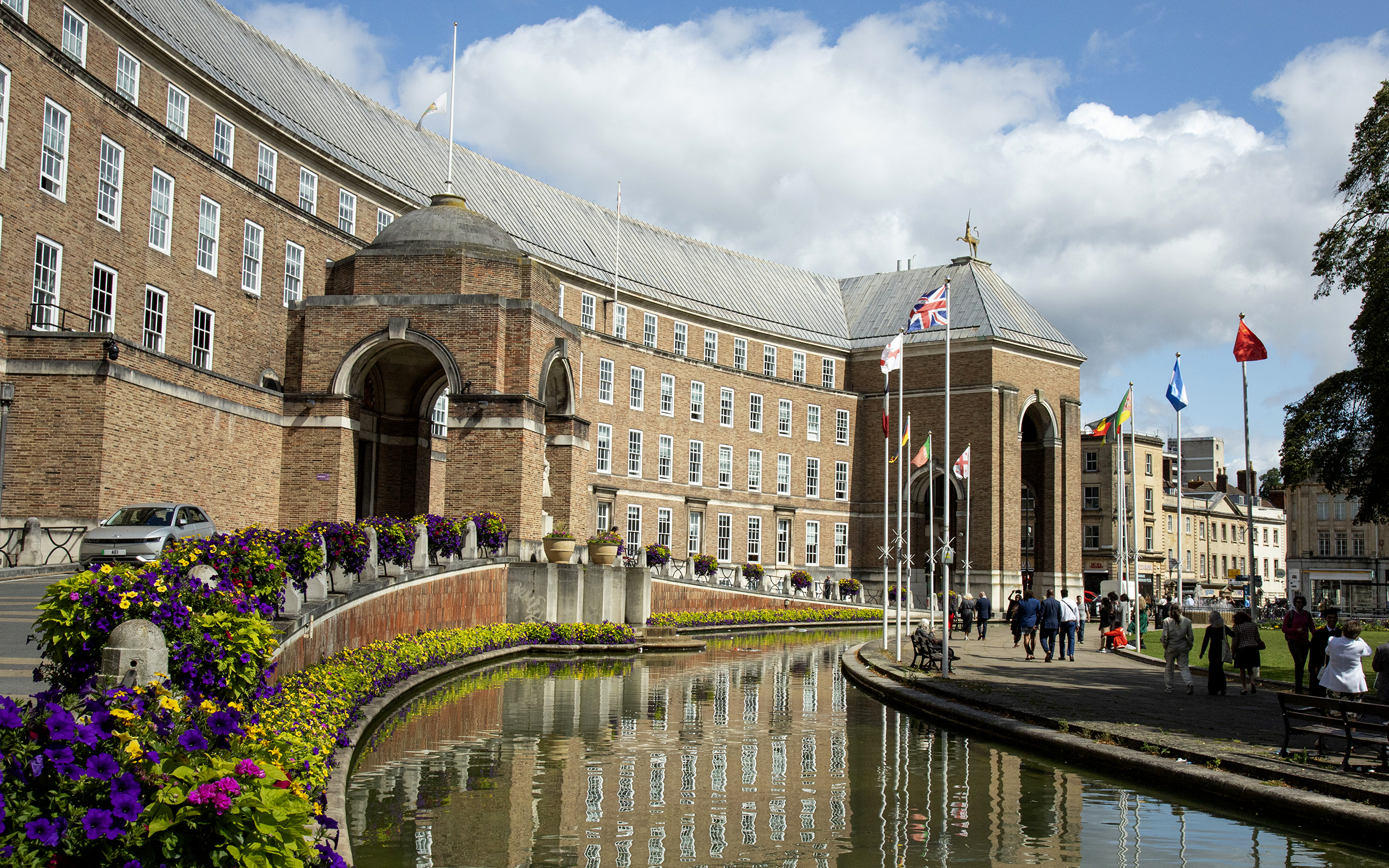 City Hall on College Green, a moat in front and flowers