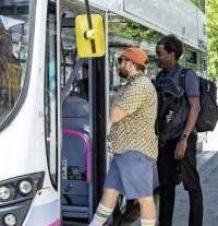 Two male passengers getting on a bus