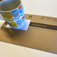 An envelope with a cup on it