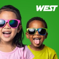 A child wearing sun glasses smiling.
