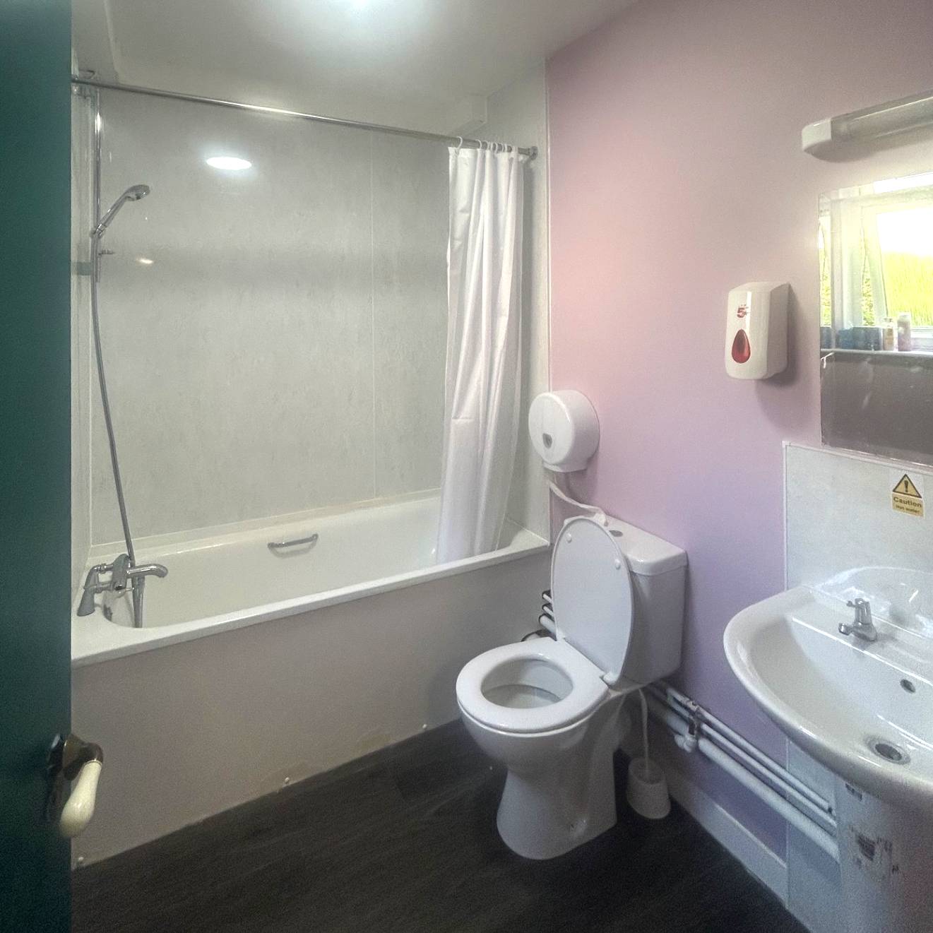 Bathroom with shower over bath, toilet and sink