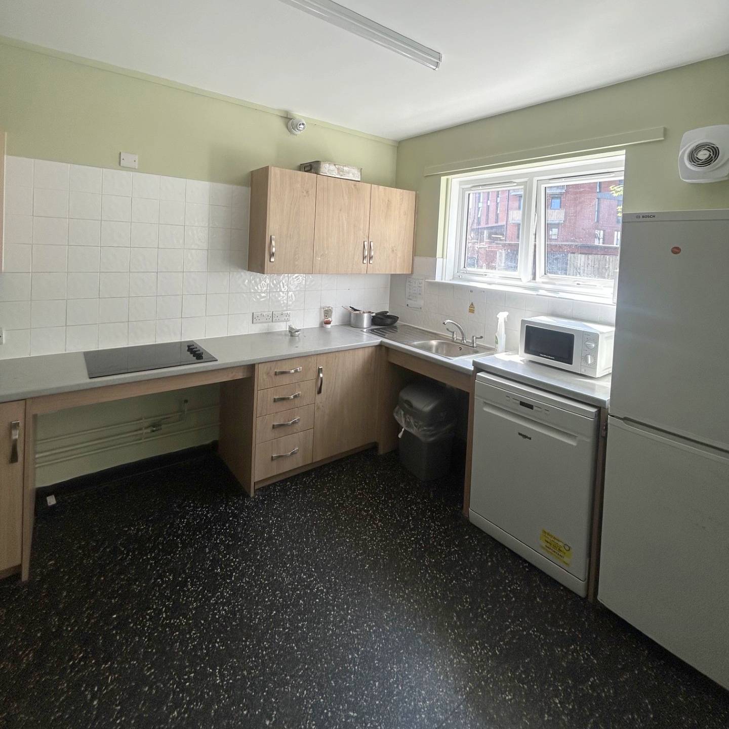 Kitchen with hob, microwave and fridge freezer