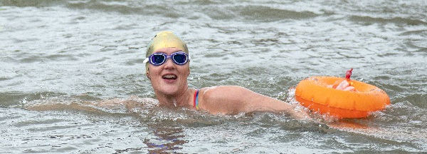 Swimmer in Bristol Harbour wearing a swim cap and using a tow float