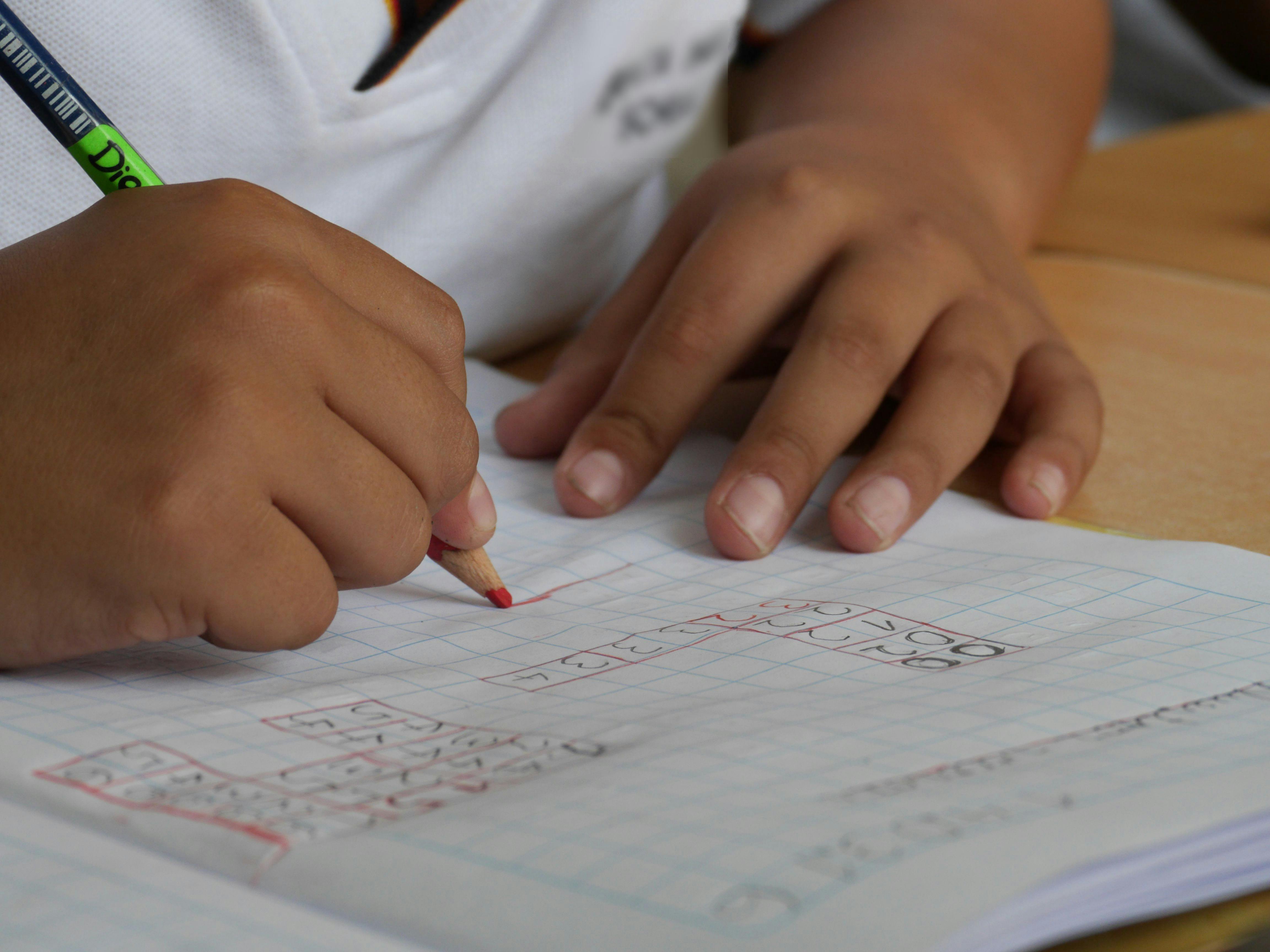 Child writing on a piece of paper