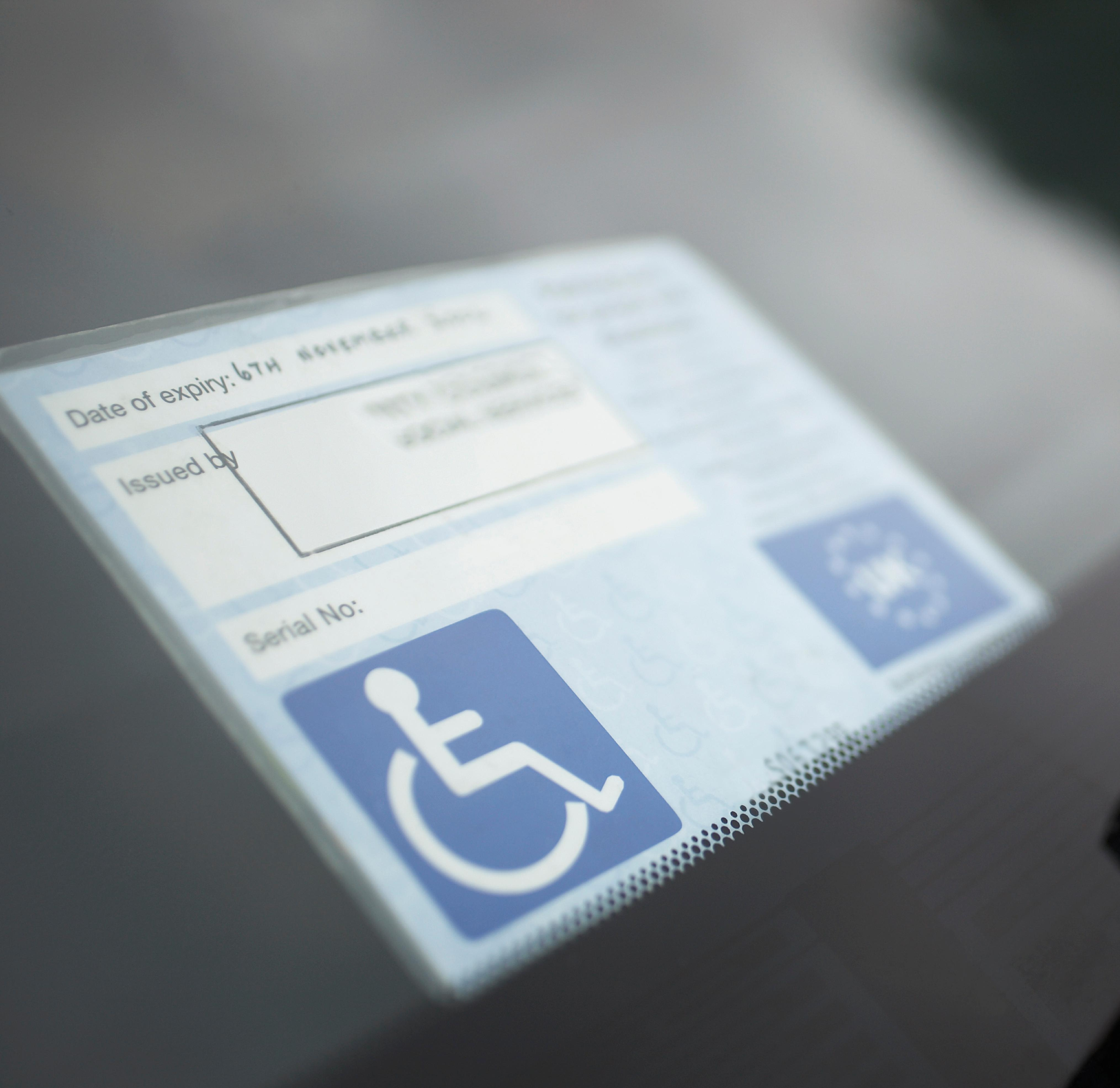 Close up of a blue parking badge in a car.