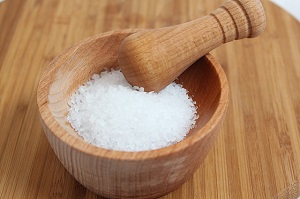 A wooden bowl with salt in
