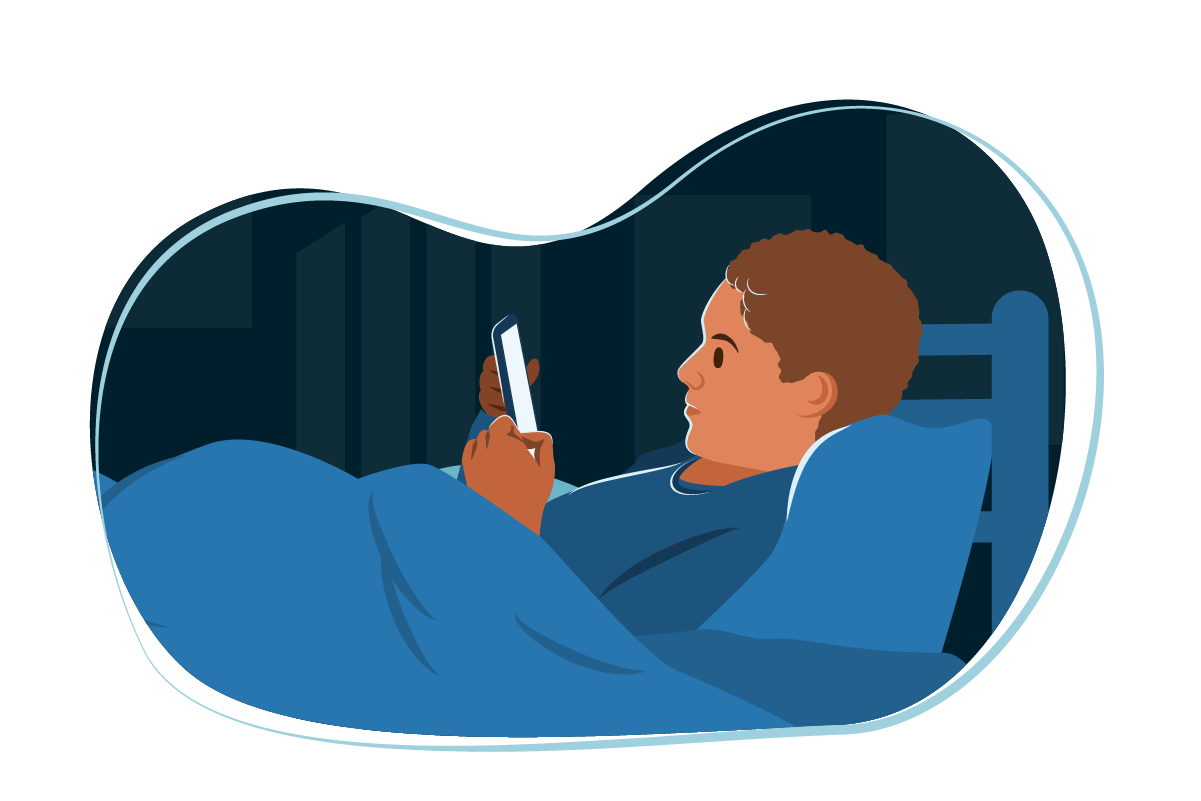 Teenage boy at night looking at phone