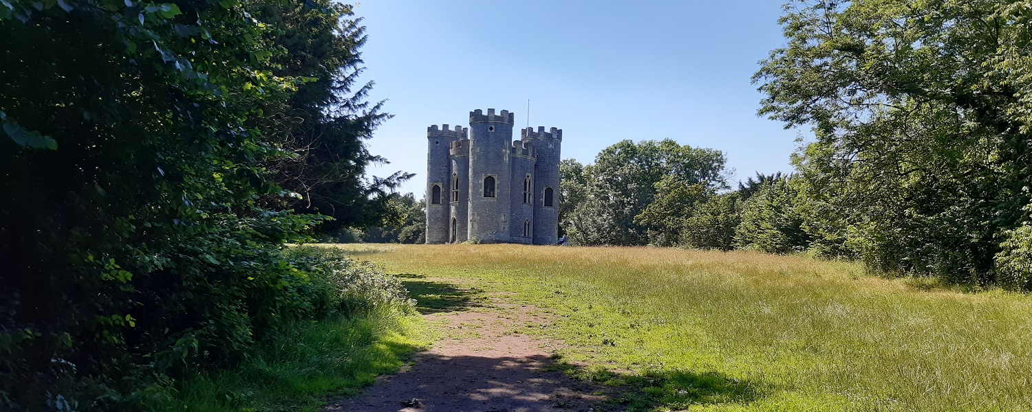 A castle in a green and wooded area