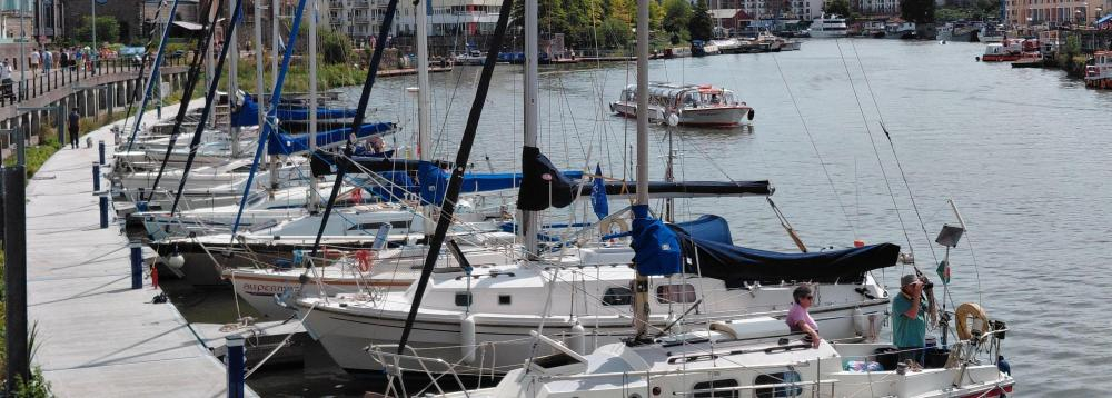A row of boats moored together 