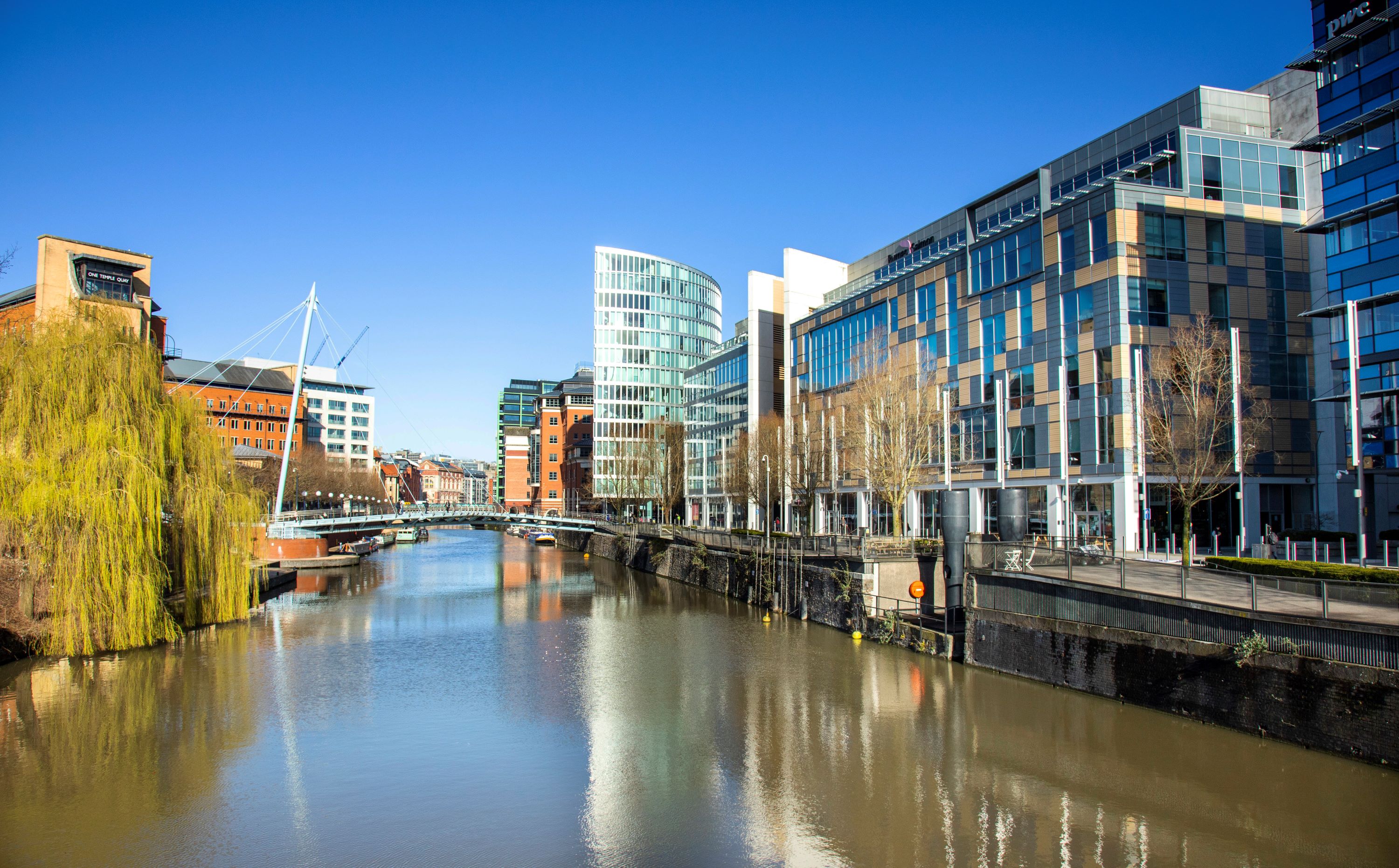 A stretch of water with buildings on one side, some trees on another side