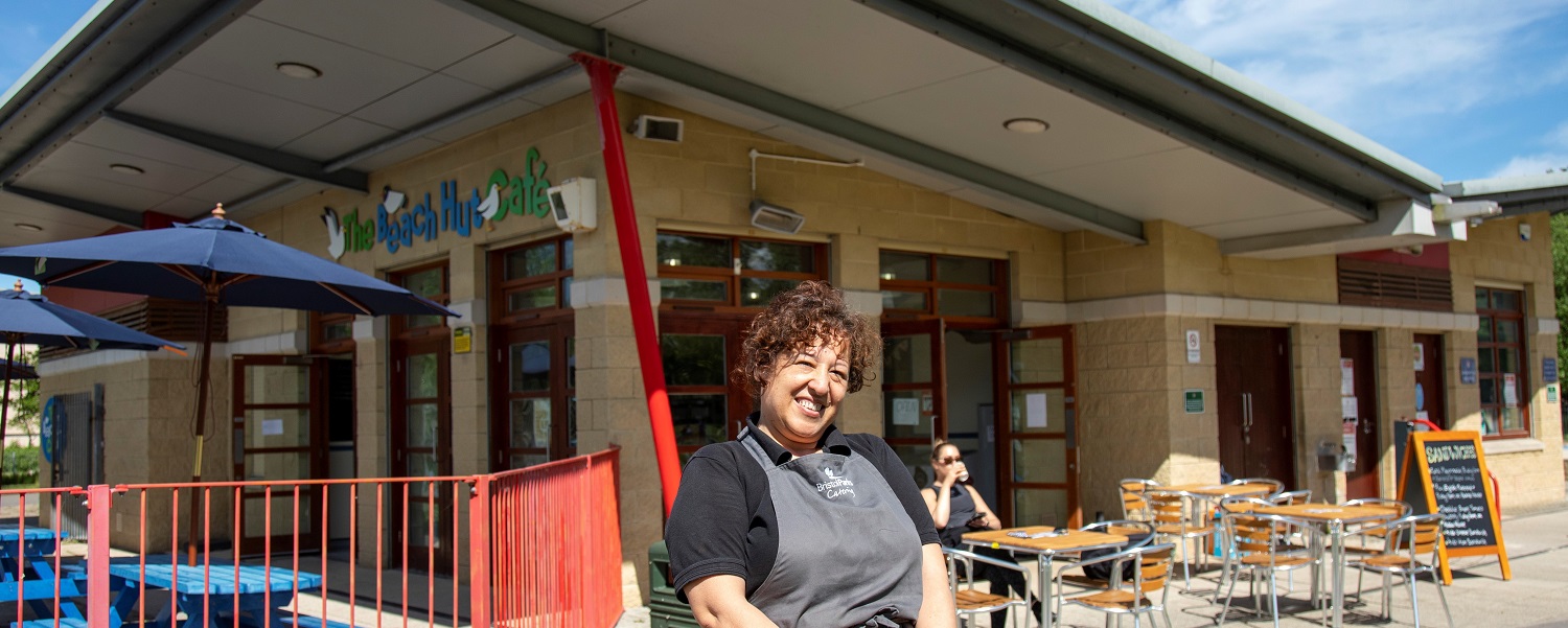 Member of staff outside The Beach Hut Cafe