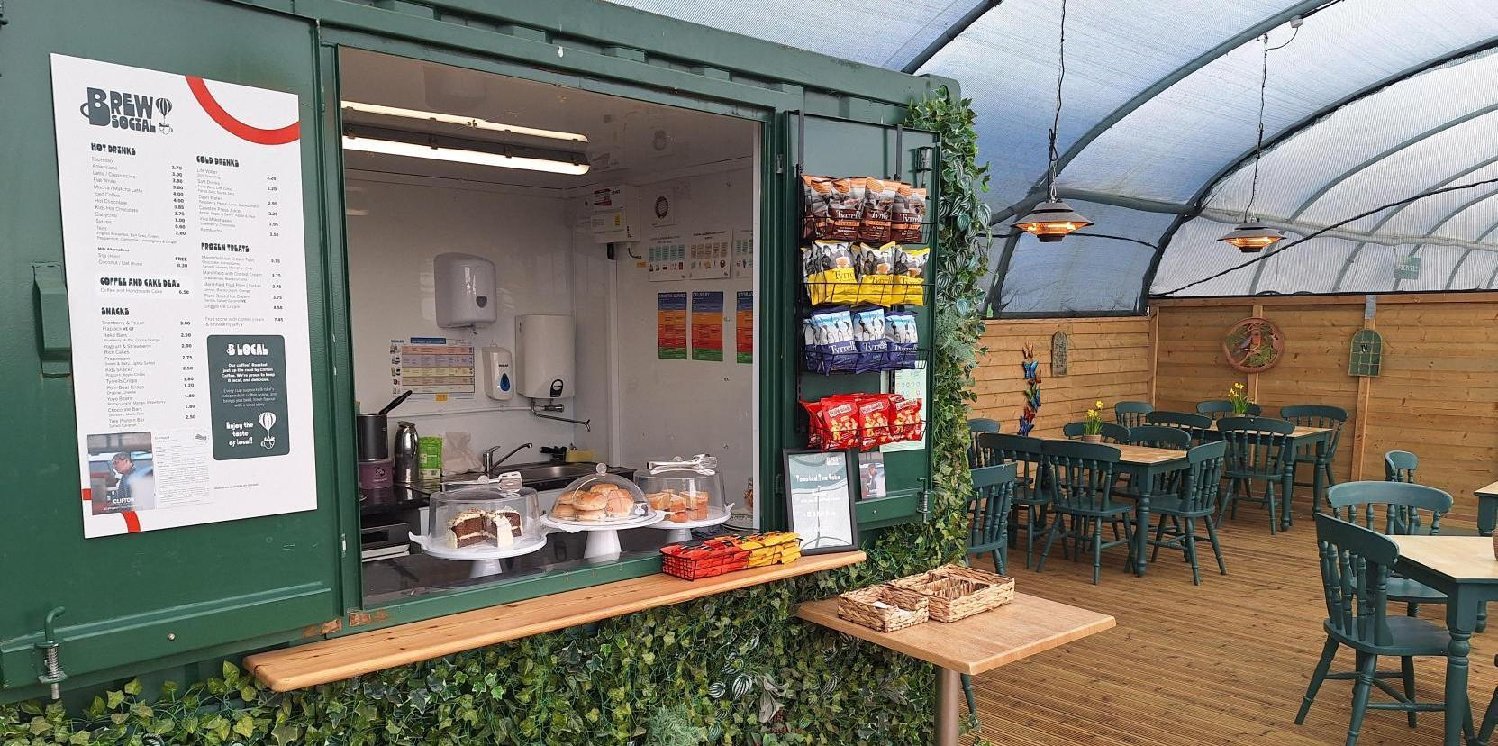 A close up of the till area at The Plant Cafe. Greenery adorns the kiosk.