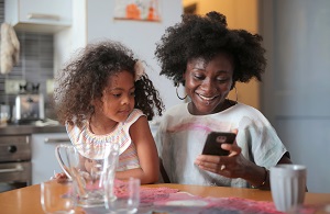 A woman and girl having breakfast in the kitchen