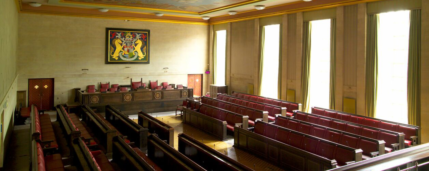 a heritage room with leather pews and the Bristol crest on the wall