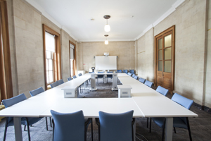 a large meeting room with floor to ceiling windows in city hall