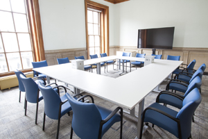 a bright and airy meeting room with floor to ceiling windows