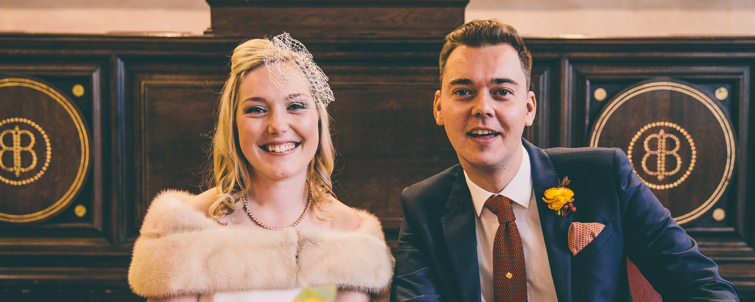 a young bride and groom smiling at the camera