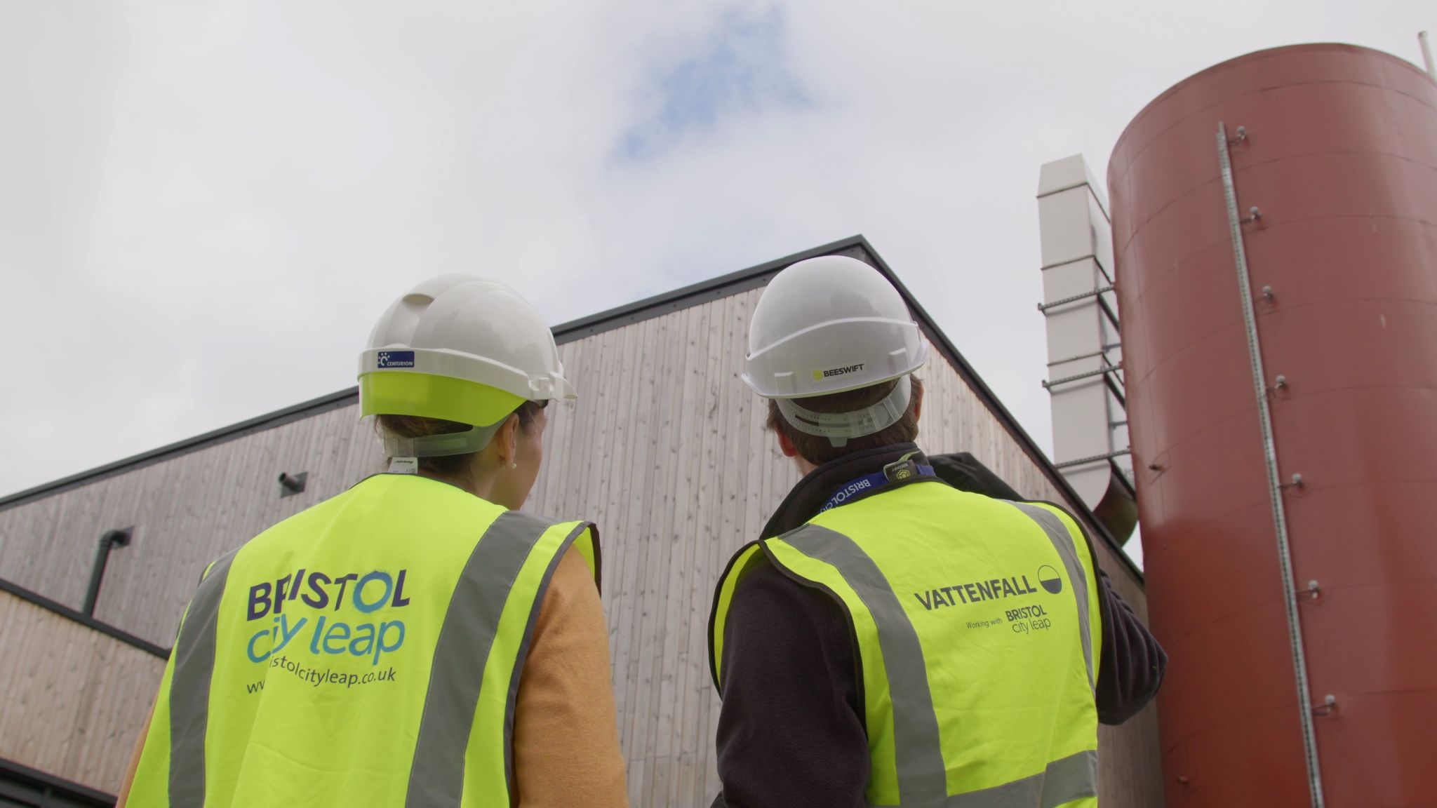 Workers in hi-viz vests pointing