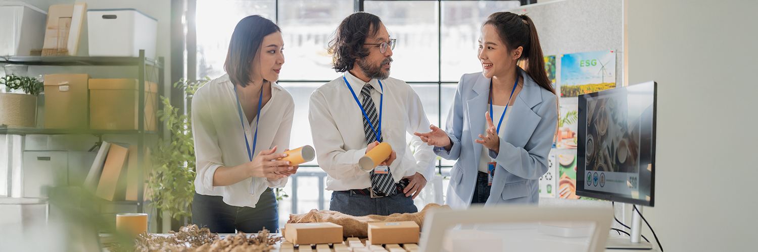 2 women and a man discuss a range of soap products in a shop