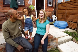 A couple with a young girl smiling