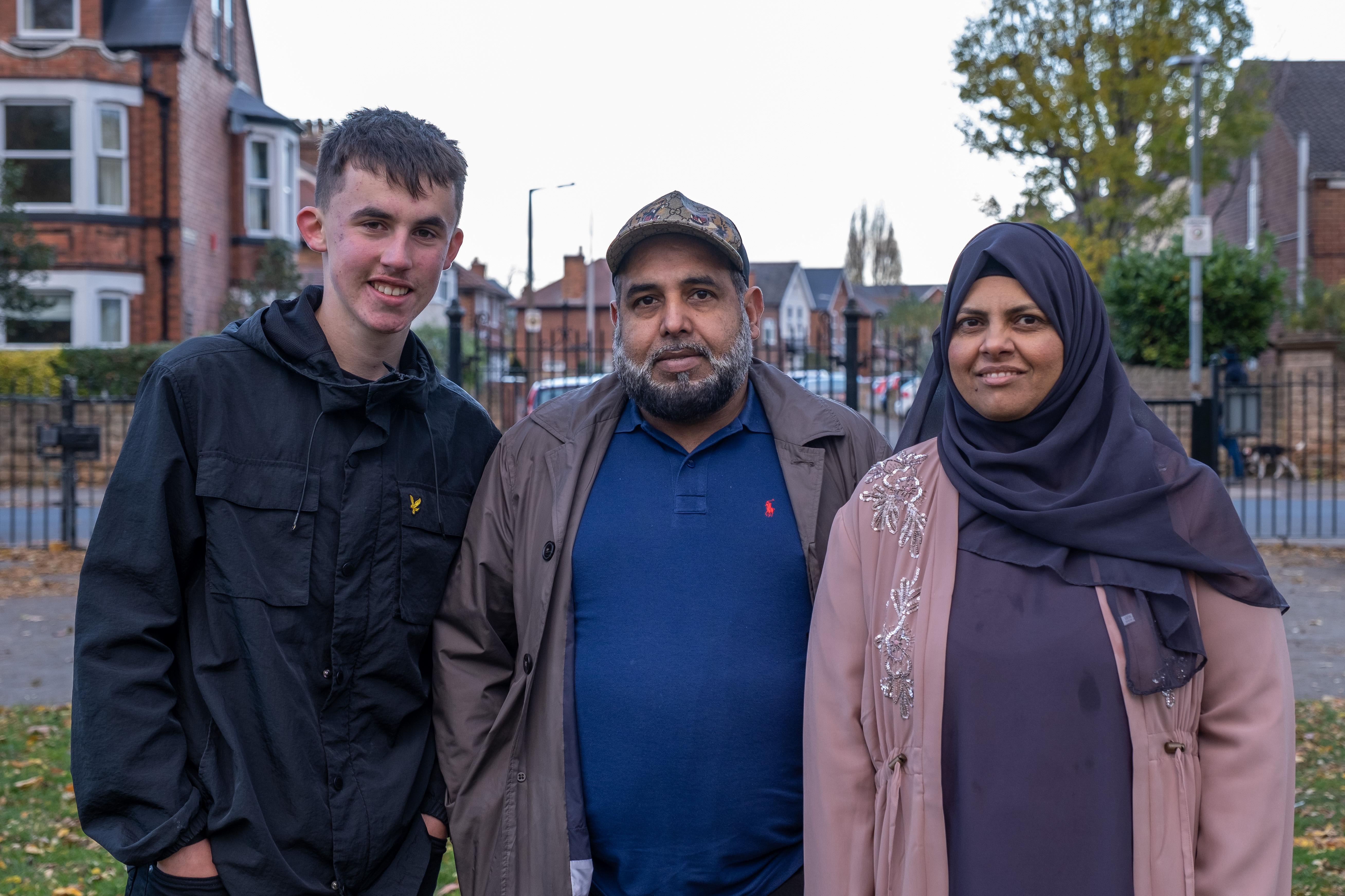 A man, a woman and a teenage boy smiling