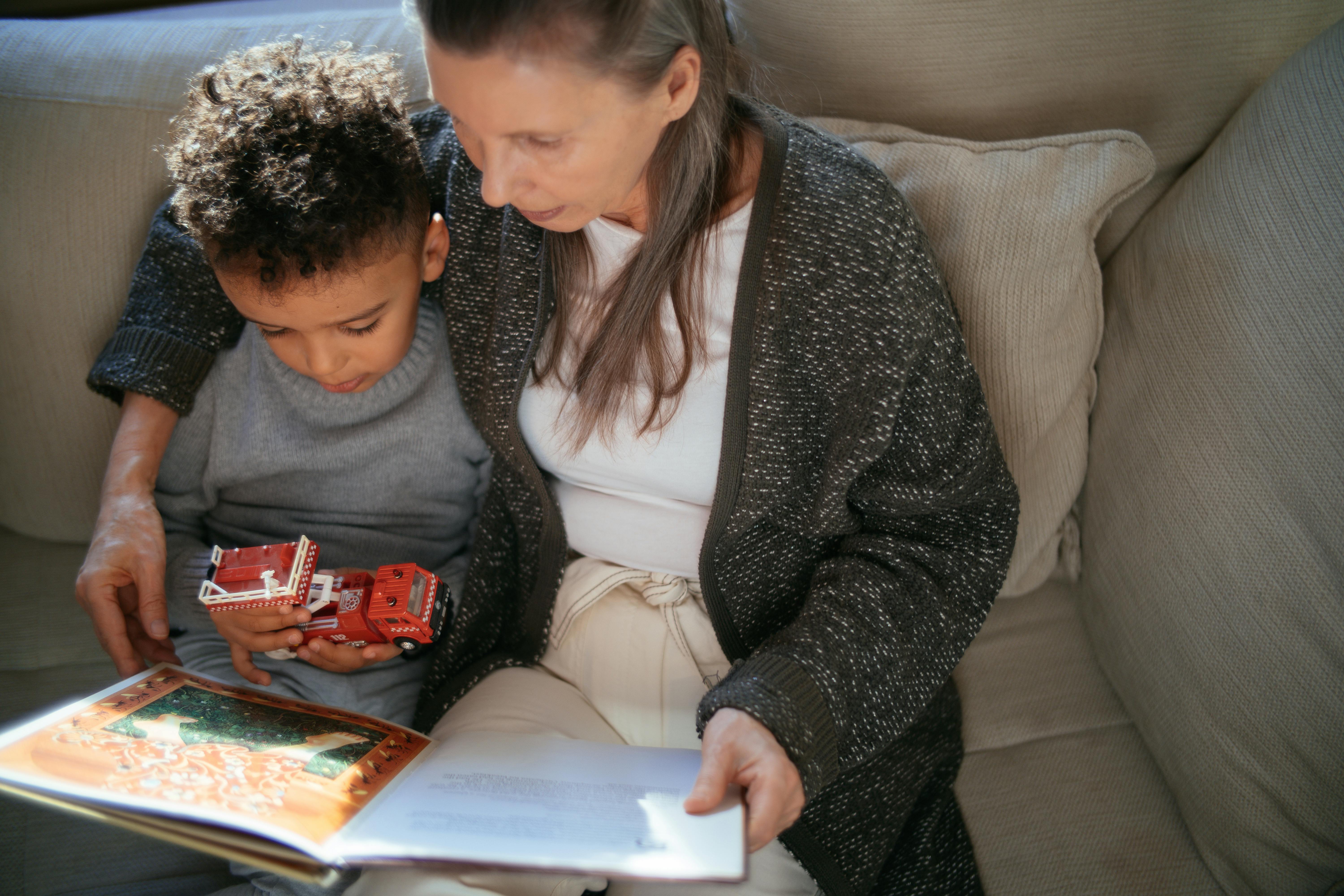 Woman and little boy reading on sofa