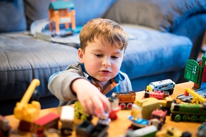 A young boy playing with lego bricks
