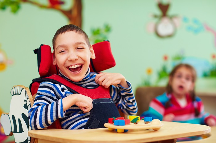 Child in a chair playing with a toy
