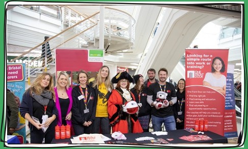 A group of people, including the Lord Mayor, at a stand offering employment advice and support. 