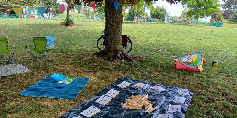 Games laid out on mats in a park