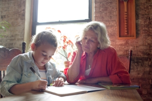 Grandmother with her granddaughter while she is doing homework