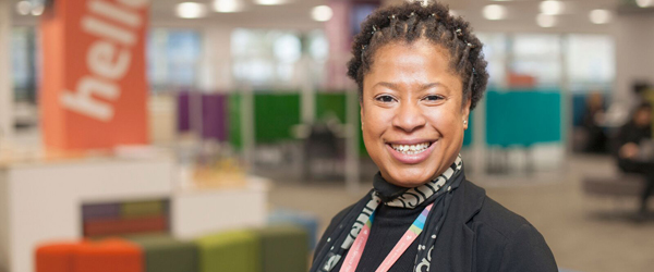 a smiling black woman in a council office
