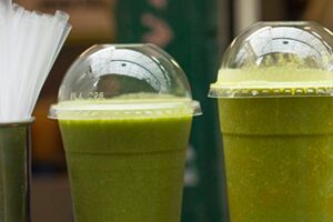 Green juice in plastic cups