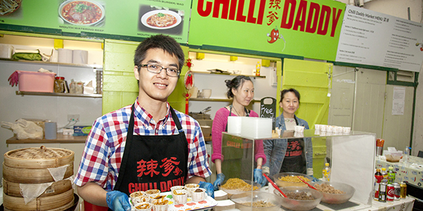 A man smiling with a plate of food