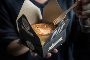 A pie in a small cardboard container