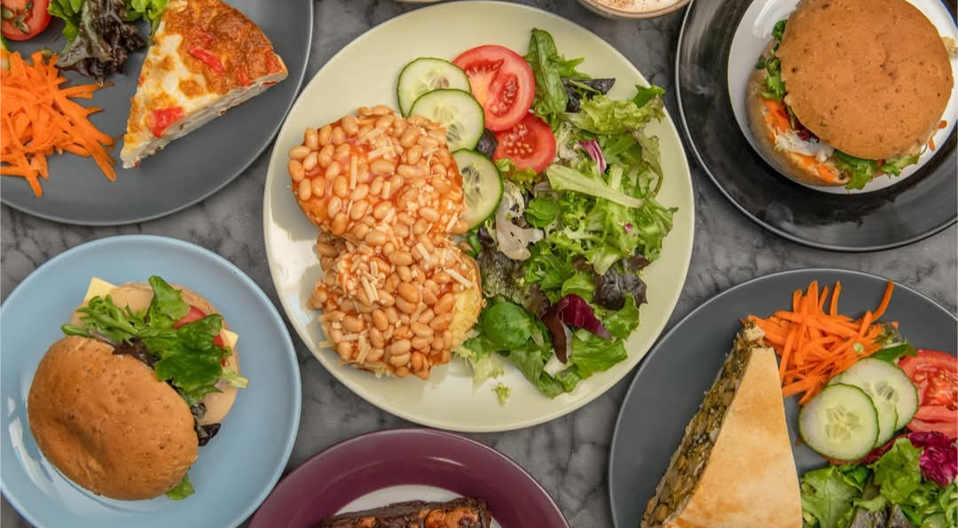 Several plates with colourful vegan food 