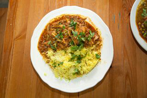 A plate of hot food on a wooden table