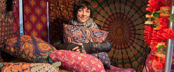 A woman selling cushions and rugs