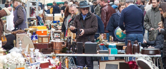 A man with a hat on in a busy market