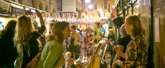 Customers browsing market stalls at night