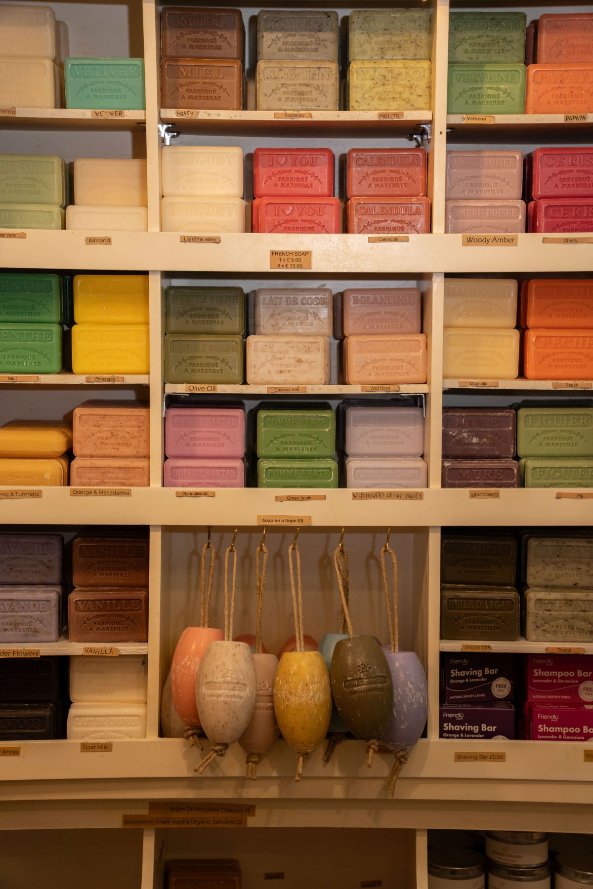 Some colourful soaps in different shelves