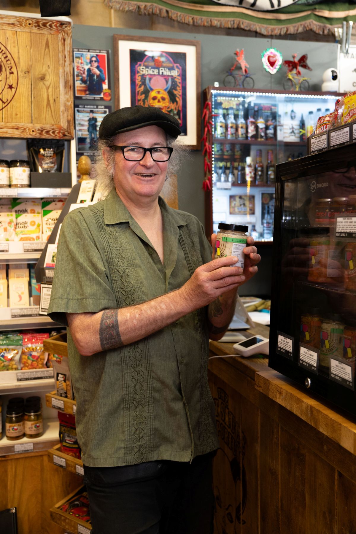 Hot Sauce Emporium employee holding a jar of sauce