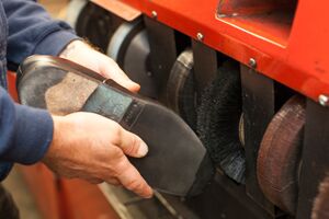 Man polishing a shoe in a shop