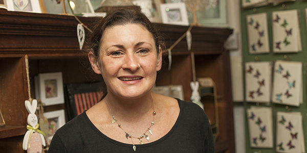 A lady smiling in her shop