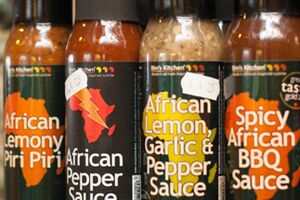 Bottles of pepper and BBQ sauce on a shelf