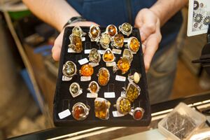 A tray of rings with orange stones in them