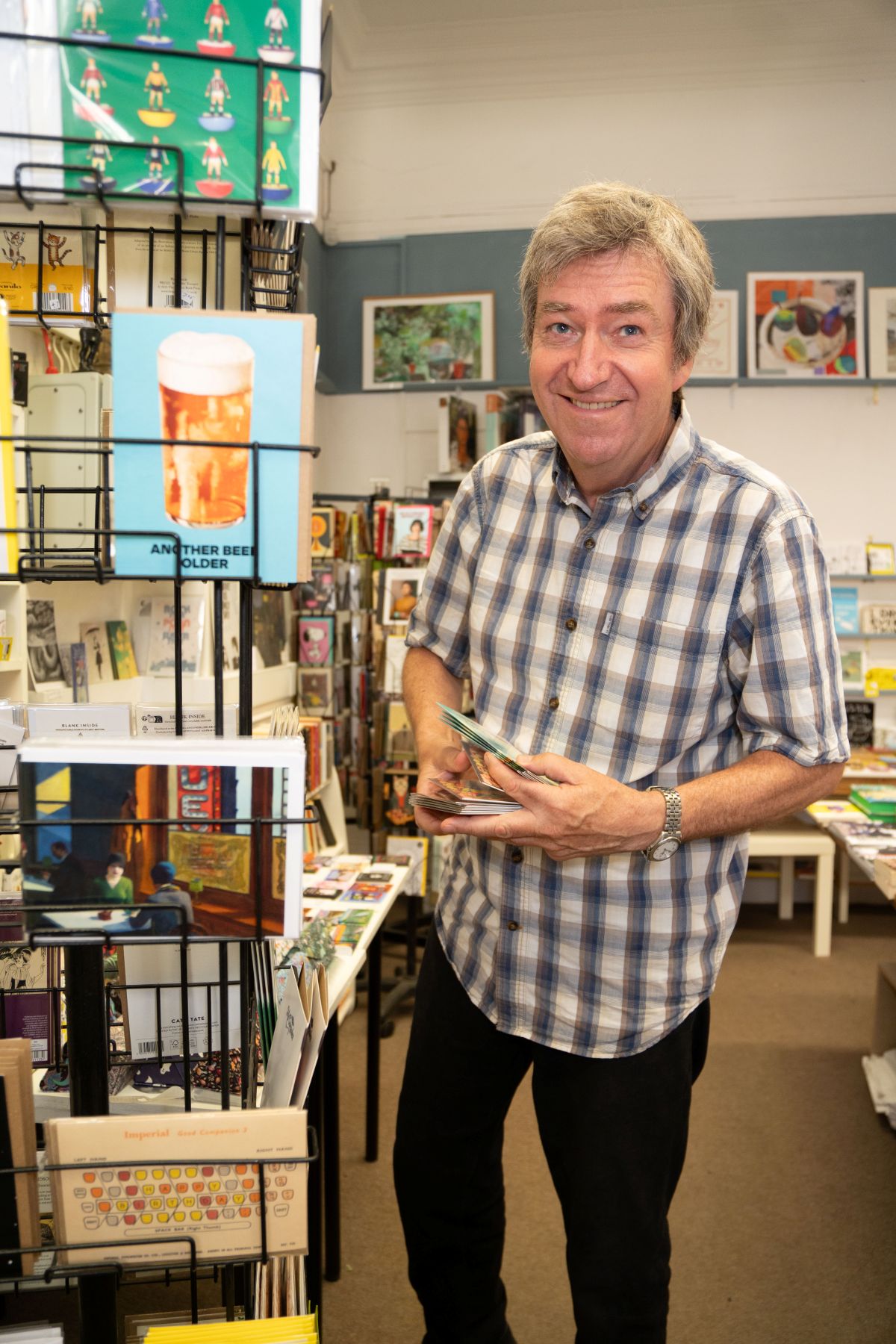 A man standing next to some cards