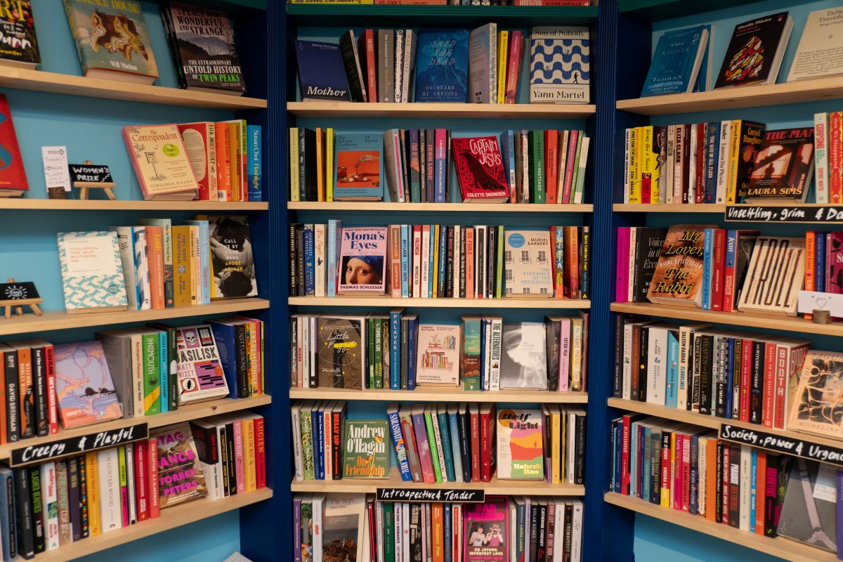 Three bookshelves with colourful books in them